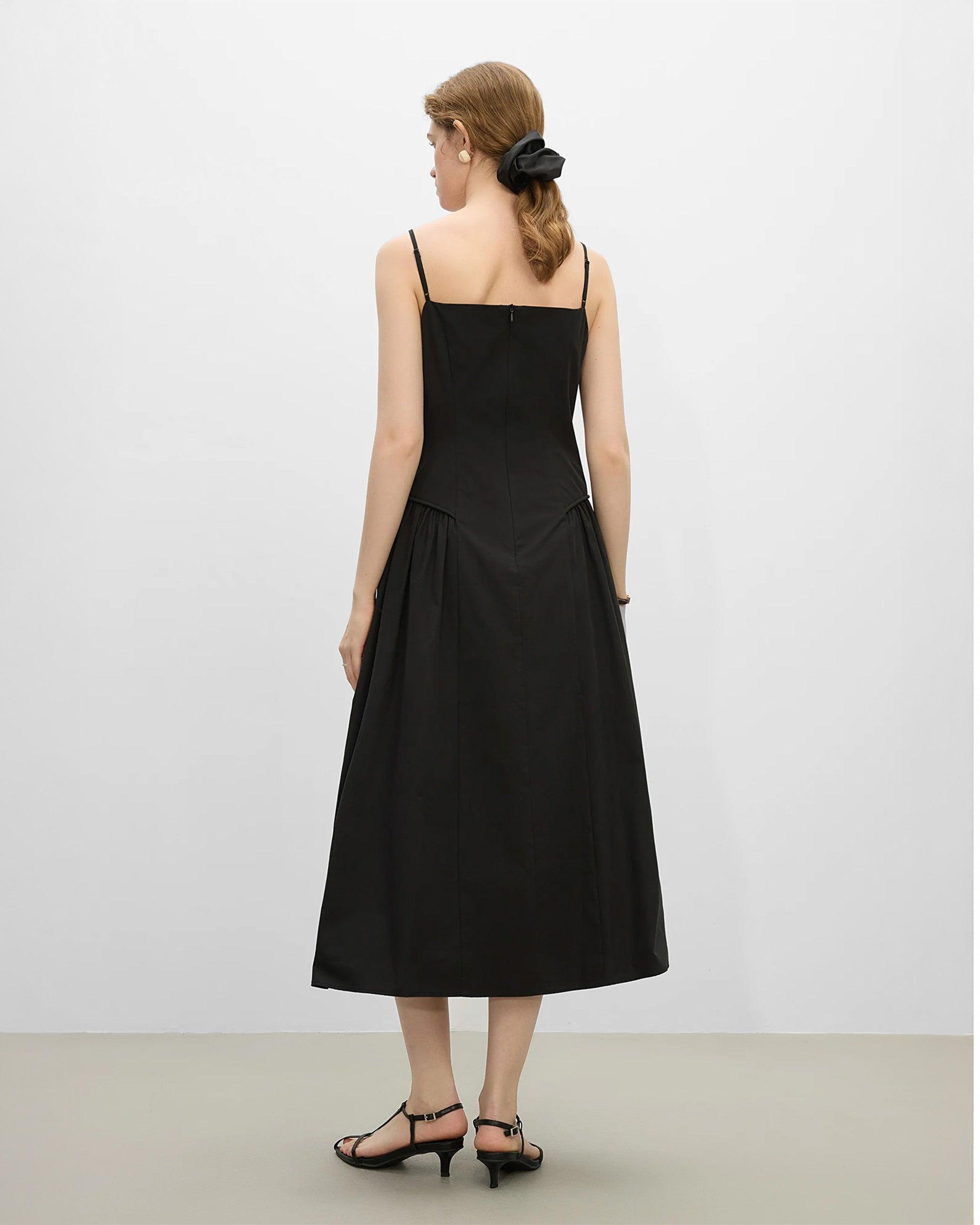 Vestido corte A elegante de Grevano en negro, con tirantes delgados y diseño fluido en la parte posterior.